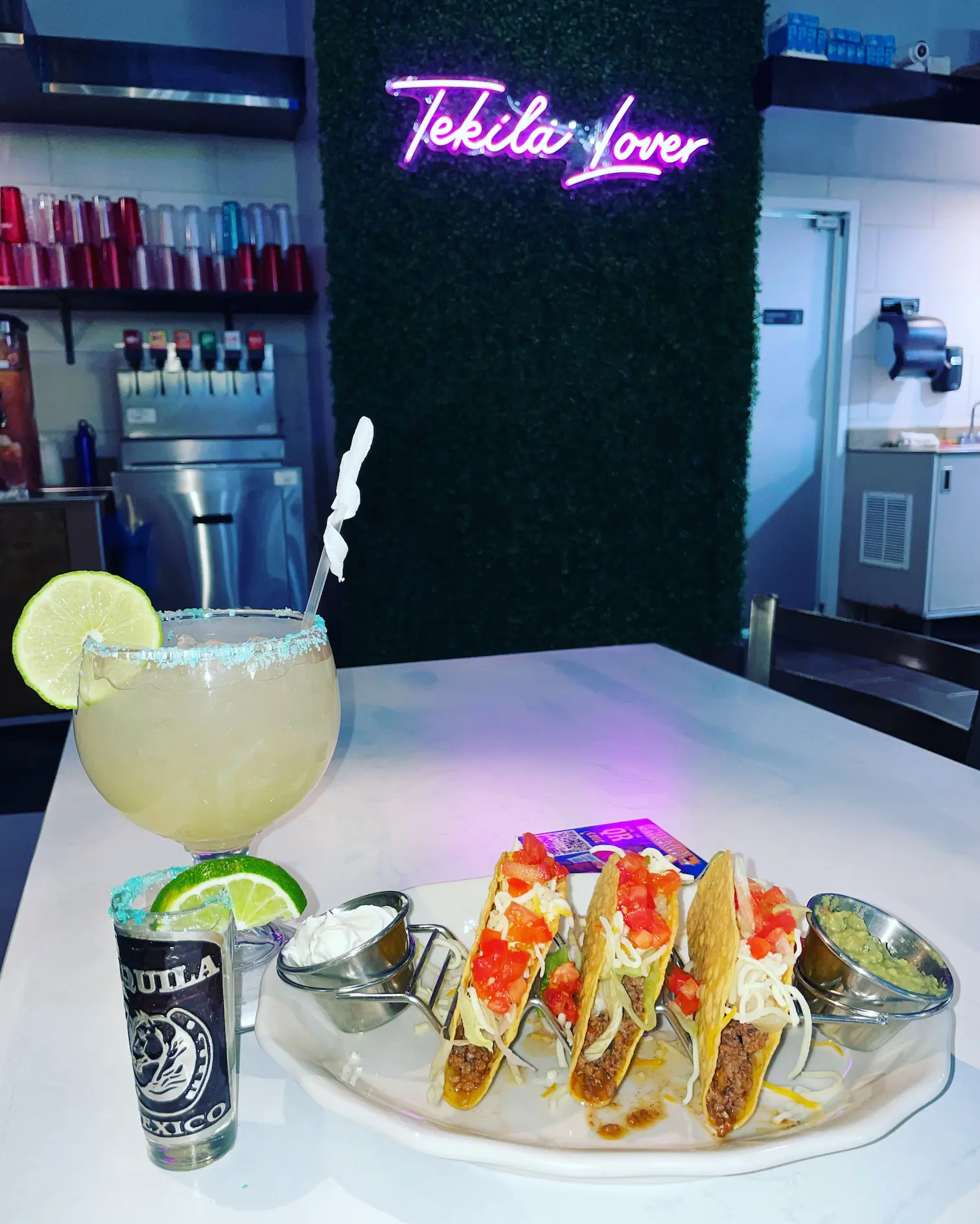 A margarita and tacos beneath the Tekila Lover sign at Tekila in Auburn.
